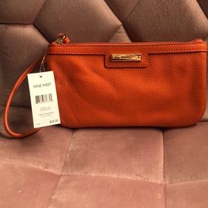 Nine west wristlet perfect size for phone and many other things. Color is orange